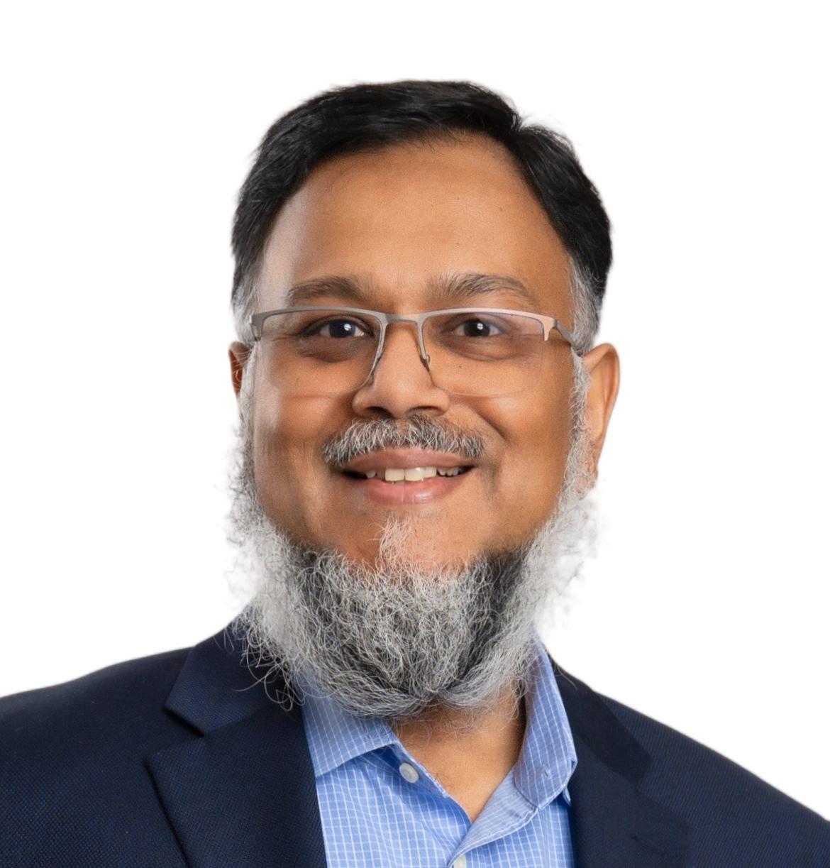 Professional headshot of Ali Dhoon, CEO and Founder at EzziTrust